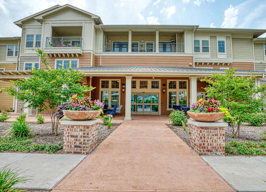 the preserve at ballantyne commons walkway to the entrance of an apartment building at Mariposa at South Broadway, Joshua Texas