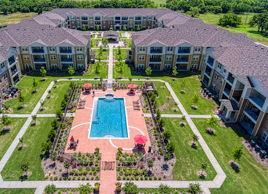 an aerial view of the courtyard and pool at the overlook estates at Mariposa at South Broadway, Joshua, TX