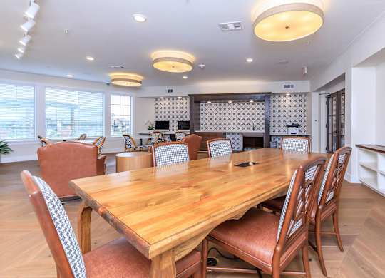 a dining room with a wooden table and chairs at Mariposa at Westchester, Grand Prairie, TX