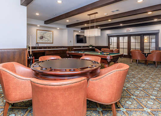 a game room with a pool table and chairs at Mariposa at Westchester, Grand Prairie, 75052
