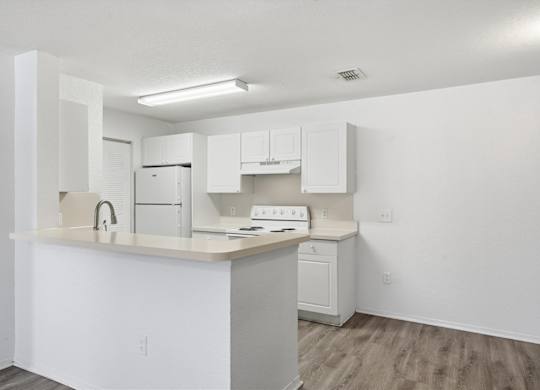 Kitchen with White Cabinets at Orchard Grove Apartments, Vero Beach, Florida