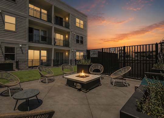 Dominium_Park Avenue West_Patio Firepit Dusk w firepit lit