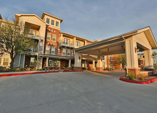 an exterior view of a building with an empty parking lot