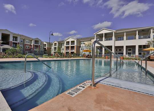 a swimming pool with apartments in the background