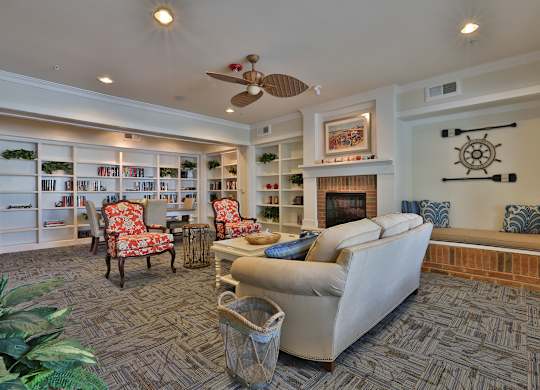a living room with a couch and chairs and a fireplace