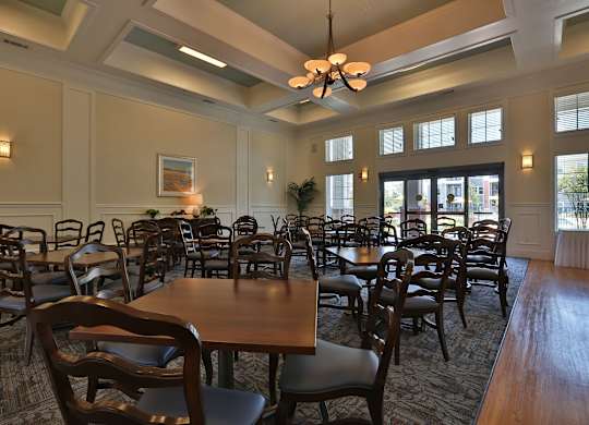 a dining room with tables and chairs and a chandelier