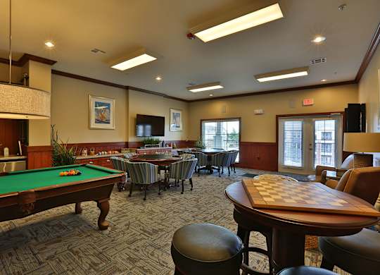 a game room with a pool table and tables
