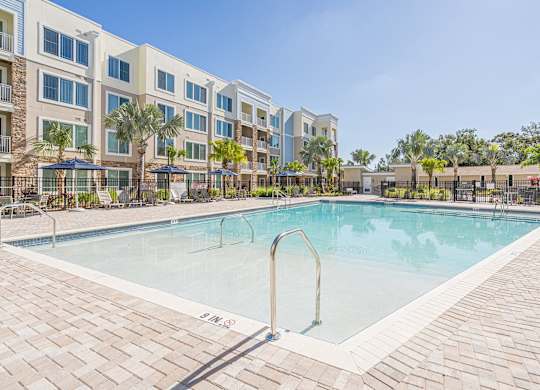 Swimming pool view with patio at Sandpiper Glen 62+ Apartments, Orlando, FL, 32825