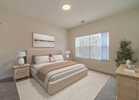 A bedroom with a large bed, a nightstand with a lamp, and a framed picture on the wall.
