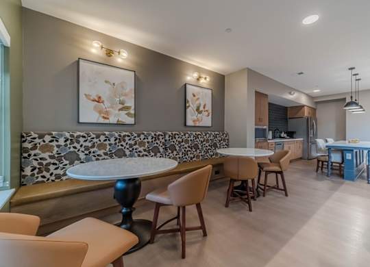 A modern dining room with a stone backsplash and wooden furniture.