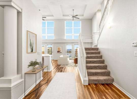 A spacious hallway with a staircase leading to the second floor.