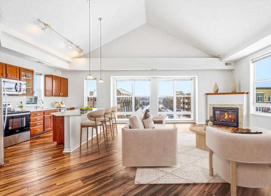 A modern kitchen with a dining area and a fireplace.