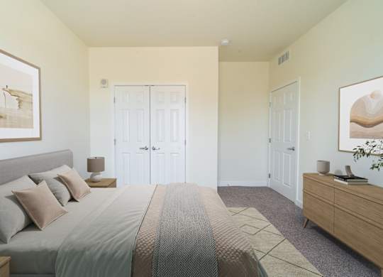 A bedroom with a bed, nightstand, and two doors.
