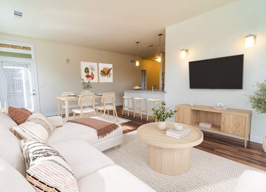 A living room with a white couch and a wooden coffee table.