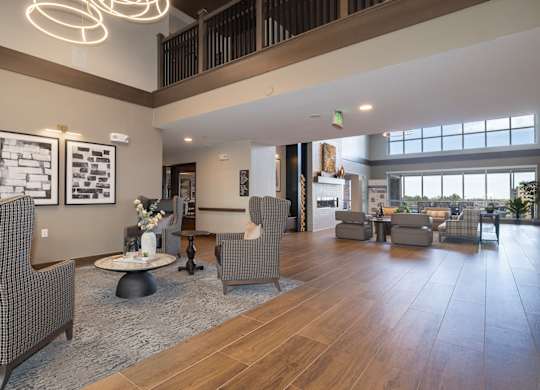 A spacious living room with a high ceiling and a large window.