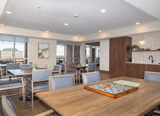 A modern dining room with a wooden table and chairs.