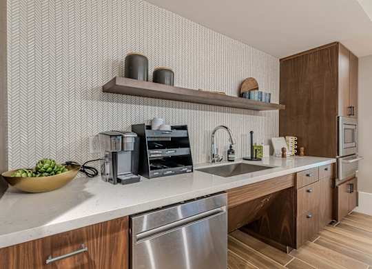 a kitchen with wooden cabinets and a sink at Willow Place 55+ Apartments, McDonough, Georgia