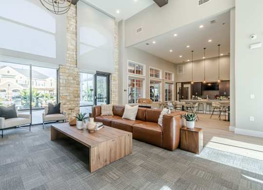 A living room with a grey carpet and a wooden coffee table.