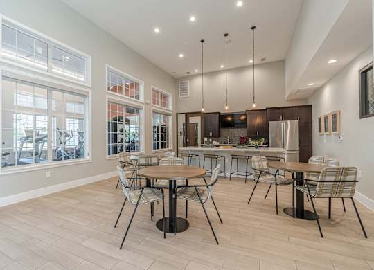 A modern dining room with a large table and chairs.