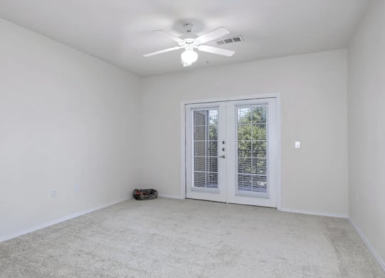 an empty living room with a ceiling fan and a window at Mariposa at Bay Colony, Texas, 77539