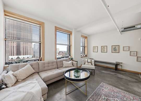 Living room with large couch at Arcade Apartments, St Louis, Missouri