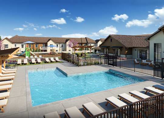 A large swimming pool surrounded by sun loungers and a wooden pergola.