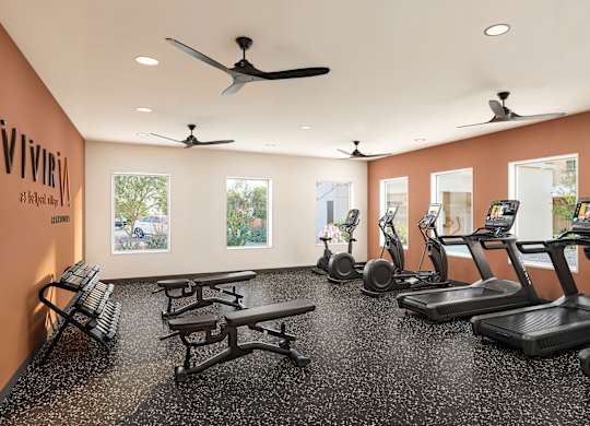 Fitness center with treadmills and weight benches at Vivir at Ballpark Village Apartments, Goodyear, Arizona