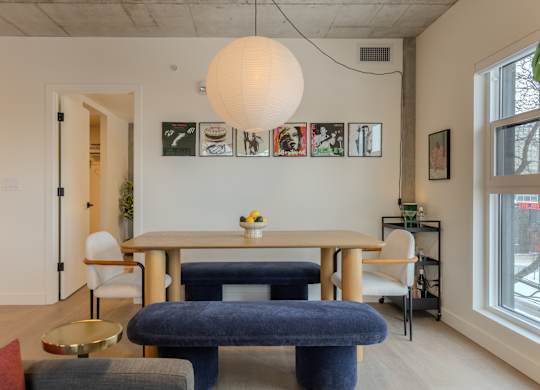 A dining room with a table and chairs.