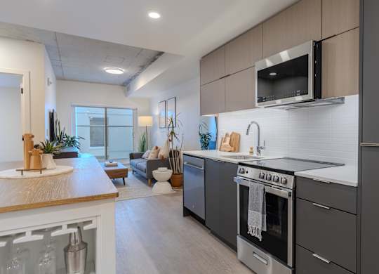 A modern kitchen with a stainless steel oven and microwave.