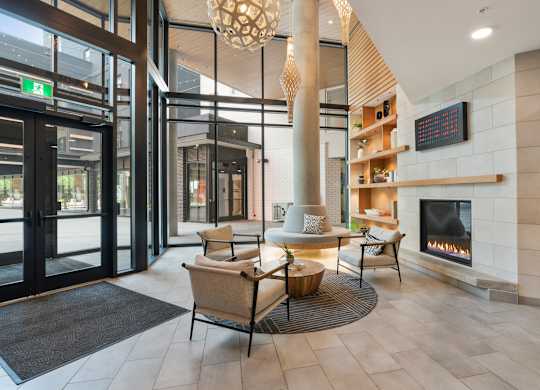 A modern lobby with a fireplace and seating area.