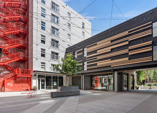A modern building with a red staircase in front of it.