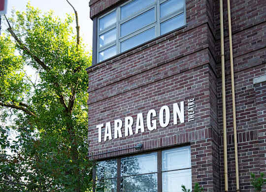 A brick building with a sign that says Tarragon.