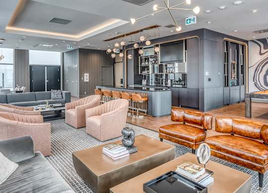 A modern living room with a grey and pink color scheme.