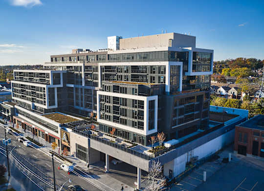A large modern building with a lot of windows and balconies.