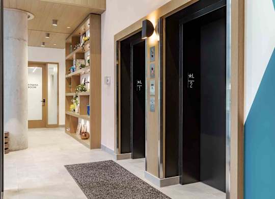 A hallway with elevators numbered 1 and 2.