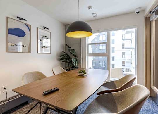 A conference room with a long table and chairs.