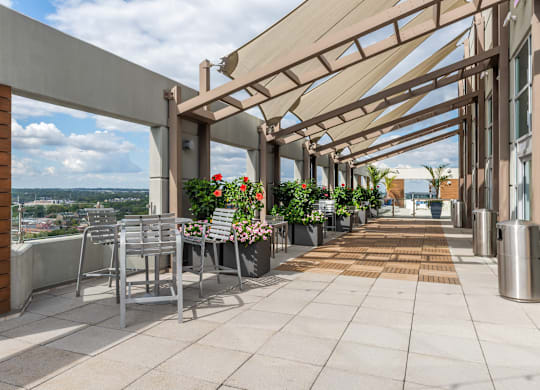 A patio with a table and chairs under a roof at Clayton on the Park Apartments, Clayton