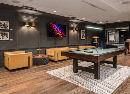A room with a pool table and a television at Clayton on the Park Apartments, Clayton, MO