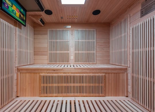 A sauna with wooden walls and benches at Clayton on the Park Apartments, Clayton 63105
