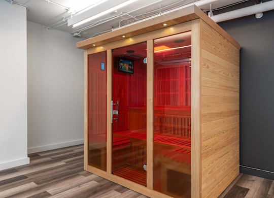 A wooden pod with red dividers in a room with grey walls at Clayton on the Park Apartments, Missouri