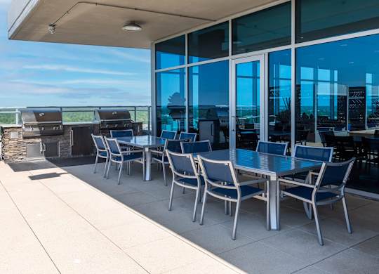 A table with chairs is on a patio.