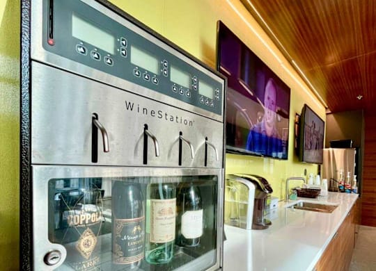 A wine cooler with several bottles of wine inside at Clayton on the Park Apartments, Missouri, 63105