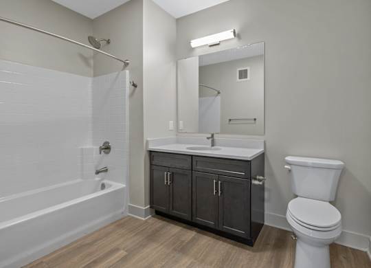 A bathroom with a white toilet, a white sink, and a white bathtub.