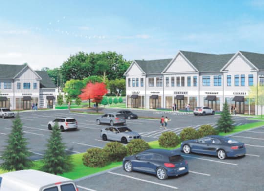 A parking lot with cars and a building in the background.
