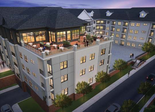A large, modern building with a lot of windows and a spacious courtyard.