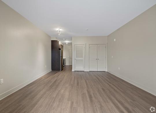 A room with wooden flooring and white walls.