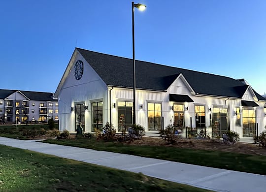 A white building with a black roof and a circular emblem on the front.