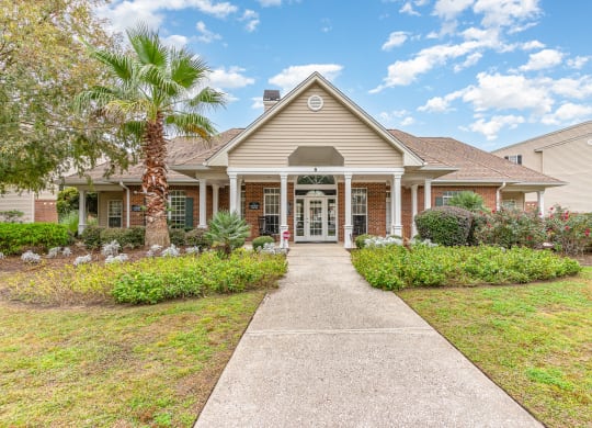 the front of a house with a walkway and a palm tree at Litchfield Oaks Apartments, Pawleys Island, 29585