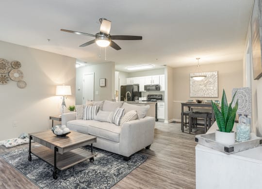 a living room with a couch and a ceiling fan at Litchfield Oaks Apartments, Pawleys Island