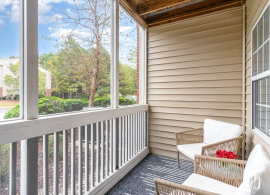 a porch with two wicker chairs and a large window at Litchfield Oaks Apartments, South Carolina, 29585